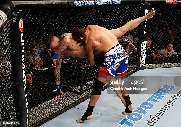 George Sotiropoulos takes down Ross Pearson during their lightweight fight at the UFC on FX event on December 15, 2012 at Gold Coast Convention and...