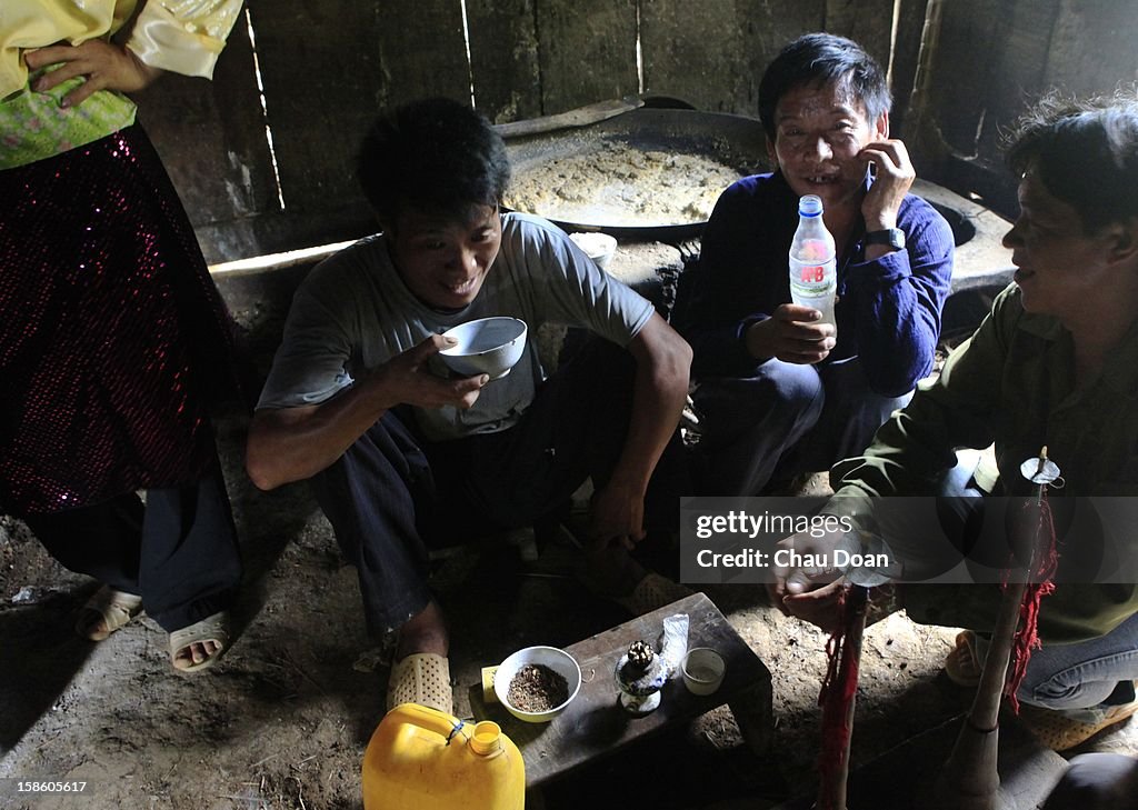 Men drink at a funeral of a 90-year-old man in Sua Can Ti...