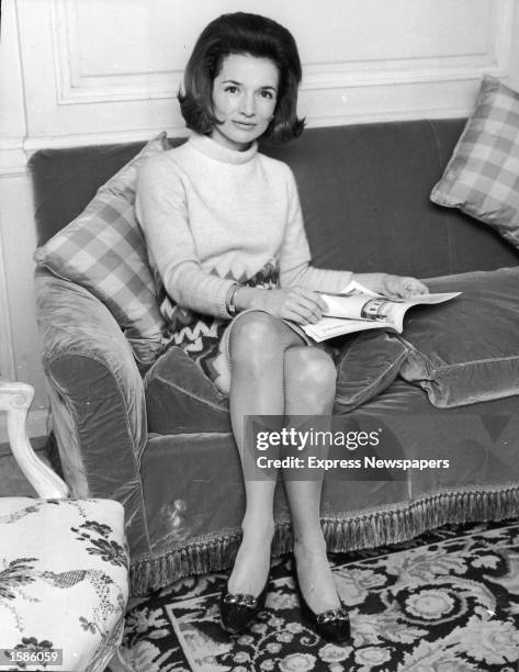 Portrait of American Princess Lee Radziwill, sister of Jaqueline Kennedy, sitting on a couch, 1960s .