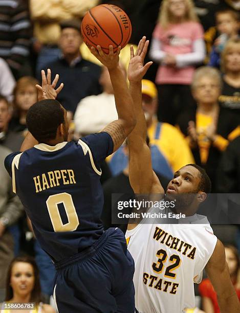 Wichita State's Tekele Cotton, right, tries to block the shot of Charleston Southern's Arlon Harper during the first half at Charles Koch Arena on...