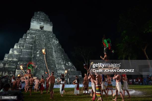 Folkloric group performs during celebrations marking the end of the Mayan age, December 20, 2012 at the Tikal archaeological site, Peten departament,...