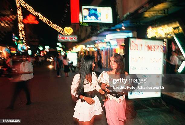 Scene from the red-light district - Patpong - women involved in the sex-industry parade outside various bars and Go-Go bars. .