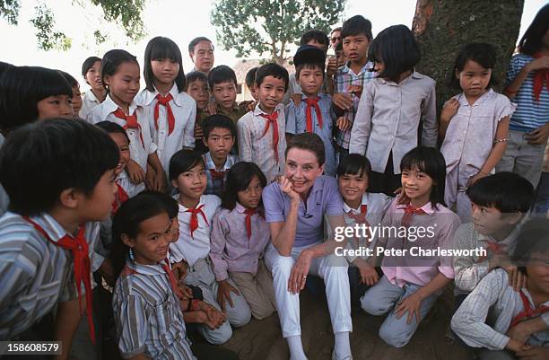 Audrey Hepburn, UNICEF's Goodwill Ambassador, takes time to get to know some schoolchildren in uniform in a small village close to Hanoi..