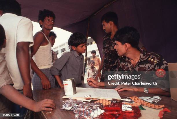 Bangladeshi military medics set up an emergency clinic where they attempt to offer medical relief to those that have survived one of the biggest...