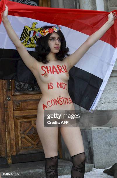 Egyptian activist Aliaa Elmahdy holds an Egyptian flag as she is naked while demonstrating with members from Ukrainian feminist group Femen against...