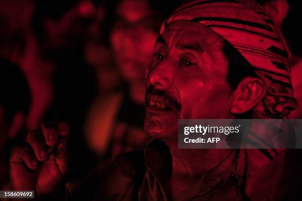 Guatemalan Maya natives take part in a ceremony of fire in the beginning of a new Maya age at the Tikal archaeological site, Peten departament, 560...