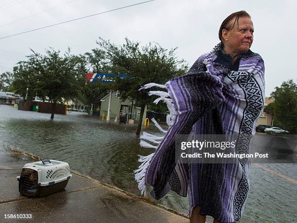 Bonnie Reavis waits for some help after being rescued with her cat KK from her home that began to flood out from the effects of Hurricane Isaac on...