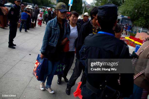 Tibetan people wait to accept the safety inspection during the Sho Dun Festival in Norbulingka on August 18, 2012 in Lhasa, China. Lhasa is the...