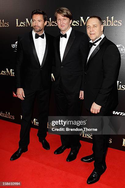 Hugh Jackman, Tom Hooper and Russell Crowe walk the red carpet during the Australian premiere of 'Les Miserables' at the State Theatre on December...