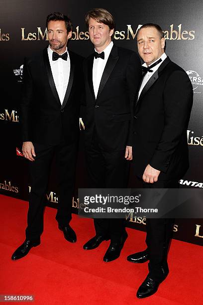 Hugh Jackman, Tom Hooper and Russell Crowe walk the red carpet during the Australian premiere of 'Les Miserables' at the State Theatre on December...