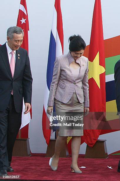 Thailand Prime Minister Yingluck Shinawatra has a paper glued to her shoes as she arrives for a photo opportunity with other leaders during the ASEAN...