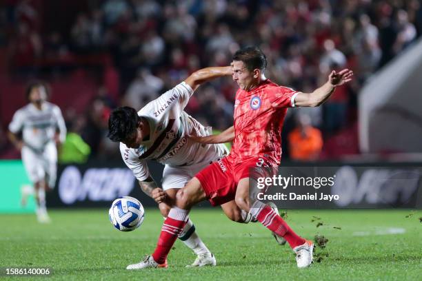 German Cano of Fluminense and Luciano Sanchez of Argentinos Juniors battle for the ball during the Copa CONMEBOL Libertadores round of 16 match...
