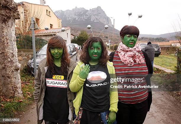 People dressed as aliens pose for the camera after the time passed 11.11 am, the time the Mayan Apocalypse was supposed to occur in Bugarach village...