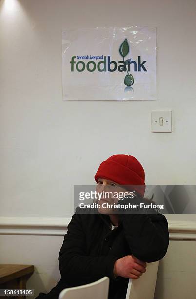 Angela Jones waits to collect essential Christmas food at Liverpool Central Foodbank on December 21, 2012 in Liverpool, England. With Christmas only...