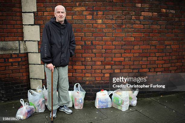 Lesley Stratton stands with bags of food he has received to feed three families over Christmas at Liverpool Central Foodbank on December 21, 2012 in...