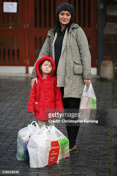 Three-year-old Lexie Hay stands with her mum Samantha Winter pose outside Liverpool Foodbank after collecting essential provisions for Christmas on...