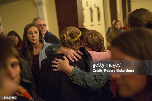 Local residents attend a memorial service at the Saint Rose Roman Catholic Church December 14, 2012 in Newtown, Connecticut for the 26 children and...