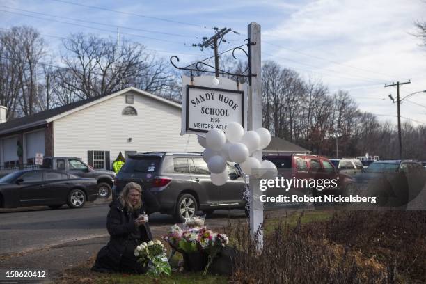 Local residents place flowers near the Sandy Hook Elementary School December 15, 2012 in Sandy Hook, Connecticut for the 28 children and faculty shot...