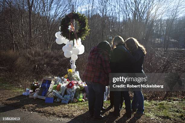 Local residents place flowers near the Sandy Hook Elementary School December 15, 2012 in Sandy Hook, Connecticut for the 28 children and faculty shot...