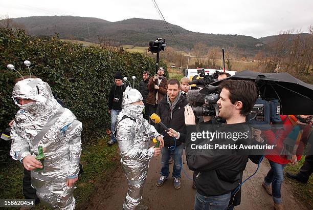 Media speak to people wrapped in silver foil in Bugarach village on December 21, 2012 in Bugarach, France. The prophecy of an ancient Mayan calendar...