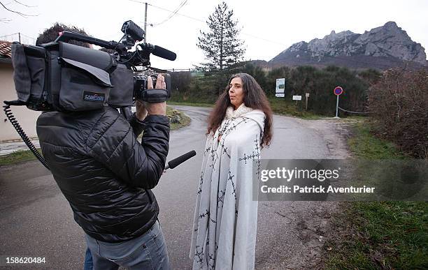 Media interview a woman in a cloak in Bugarach village after the Mayan Prophecy failed to occur on December 21, 2012 in Bugarach, France. The...