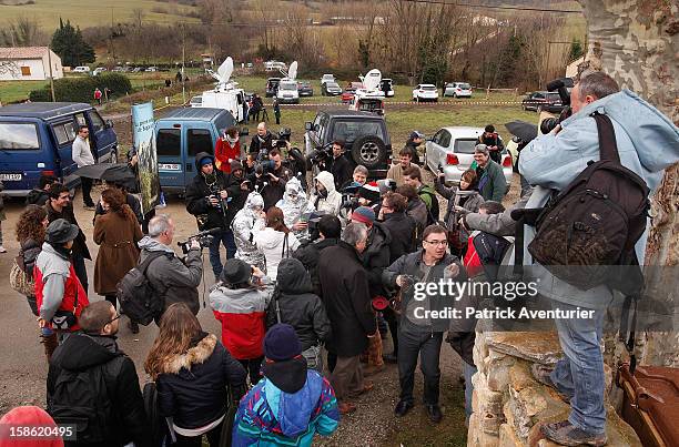 Media speak to people wrapped in silver foil in Bugarach village after the Mayan Prophecy failed to occur on December 21, 2012 in Bugarach, France....
