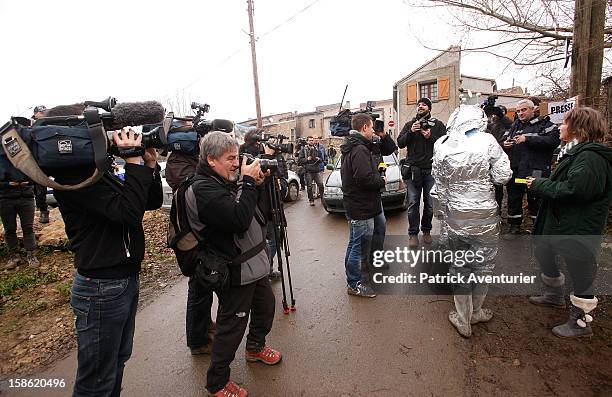 Media speak to people wrapped in silver foil in Bugarach village after the Mayan Prophecy failed to occur on December 21, 2012 in Bugarach, France....