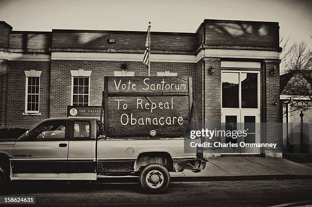 Supporter of Rick Santorum parks his truck outside the building where later in the day Santorum is to hold a victory rally on March 6, 2012 in...