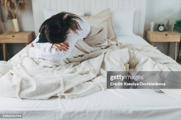 depressed woman read message at home - rude awakening stock pictures, royalty-free photos & images