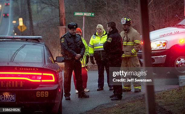 Blair County Sheriffs Deputies stand at the road block in Blair County on December 21, 2012 in Frankstown Township, Pennsylvania. According to...