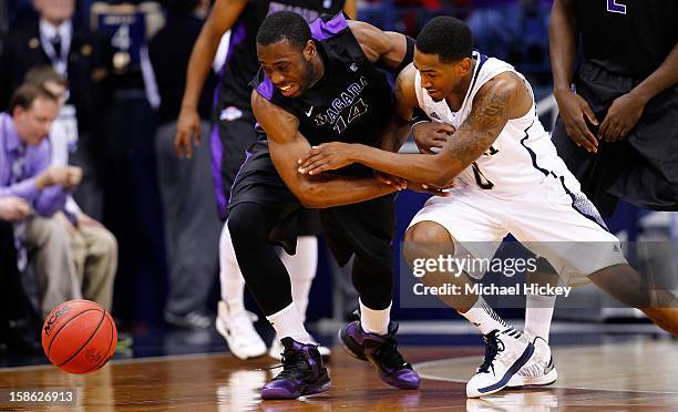 Scott Martin of the Notre Dame Fighting Irish and Eric Atkins of the Notre Dame Fighting Irish battle for a loose ball at Purcel Pavilion on December...