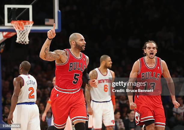 Carlos Boozer of the Chicago Bulls celbrates a three pointer by Kirk Hinrich in the third quarter against the New York Knicks at Madison Square...