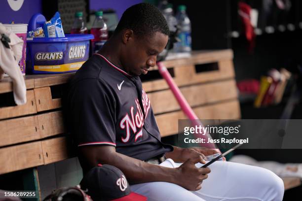Josiah Gray of the Washington Nationals looks at an iPad in the dugout during the second inning against the Milwaukee Brewers at Nationals Park on...