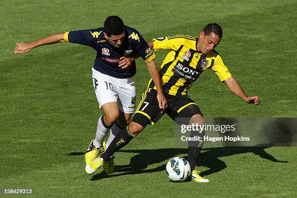 Leo Bertos of the Phoenix holds off the defence of Tomas Rogic of the Mariners during the round 12 A-League match between the Wellington Phoenix and...