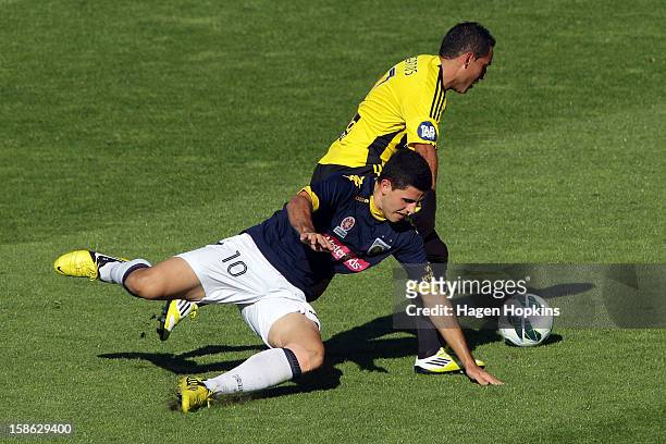 Tomas Rogic of the Mariners goes down while tackling Leo Bertos of the Phoenix during the round 12 A-League match between the Wellington Phoenix and...