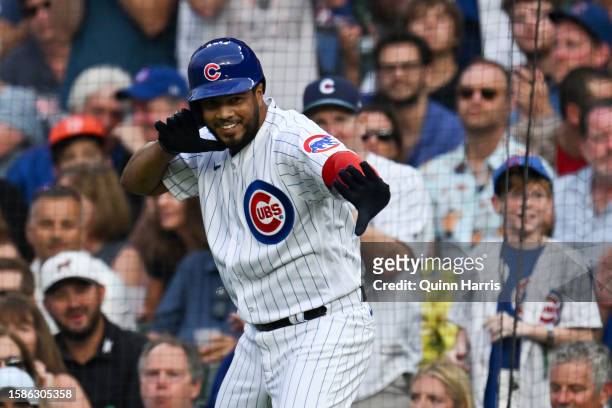 Jeimer Candelario of the Chicago Cubs celebrates after his single in the first inning against Ben Lively of the Cincinnati Reds at Wrigley Field on...
