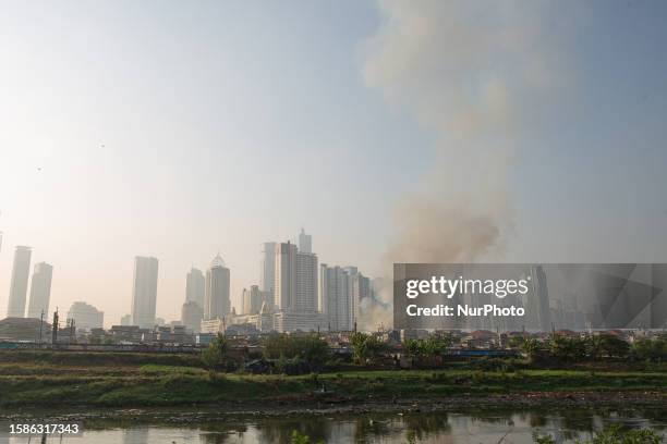 Smoke rising from huge fire at traditional market during air pollution in Jakarta on 9 August 2023, which was ranked as the most polluted city in the...