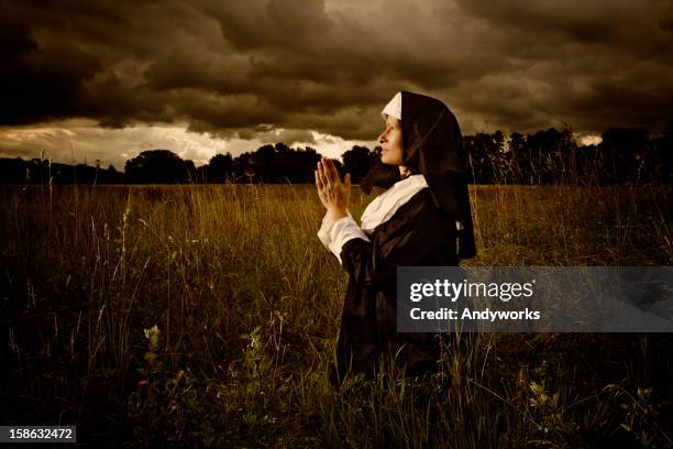 praying nun in the evening - nun outfit stock pictures, royalty-free photos & images