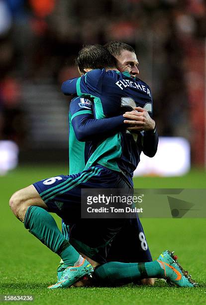Steven Fletcher of Sunderland is congratulated by teammate Craig Gardner after scoring his team's opening goal during the Barclays Premier League...
