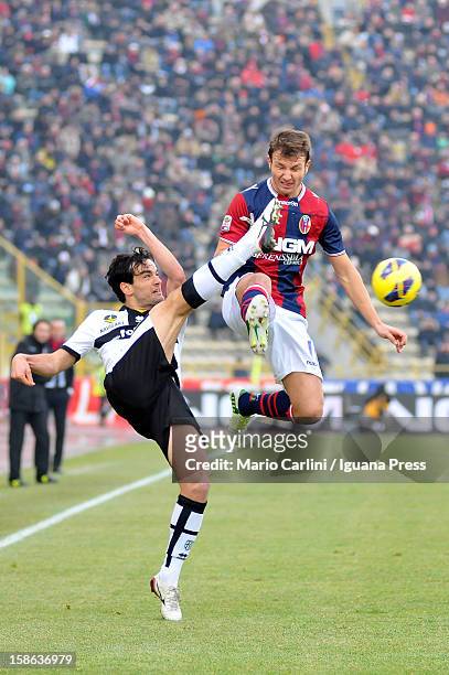 Marco Parolo of Parma FC competes for the ball with Marco Motta of Bologna FC during the Serie A match between Bologna FC and Parma FC at Stadio...