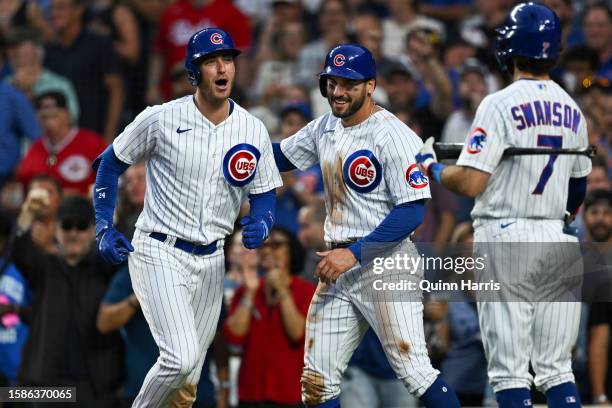 Mike Tauchman and Dansby Swanson congratulates Cody Bellinger of the Chicago Cubs for his two-run home run in the second inning against Ben Lively of...