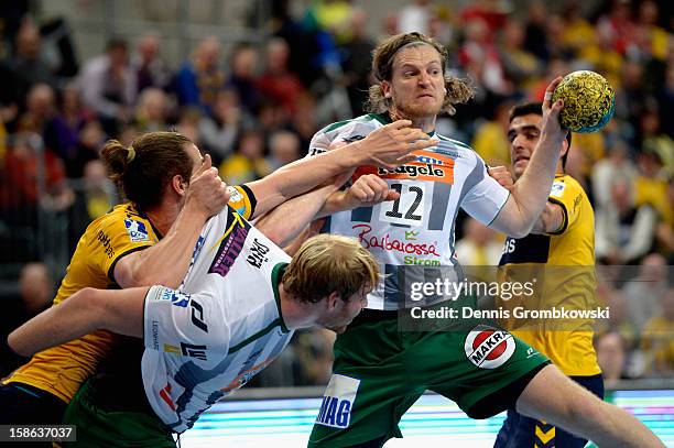 Felix Lobedank and Manuel Spaeth of Goeppingen are challenged by Kim Ekdahl du Rietz and Zarko Sesum of Rhein-Neckar Loewen during the DKB Handball...