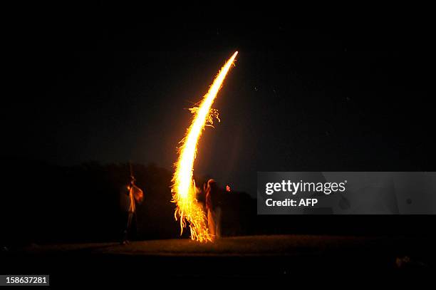 People launch fire crackers to the sky during the fire ceremony at the San Andres Archeological site in the town of Opico 32 Kms. West from San...