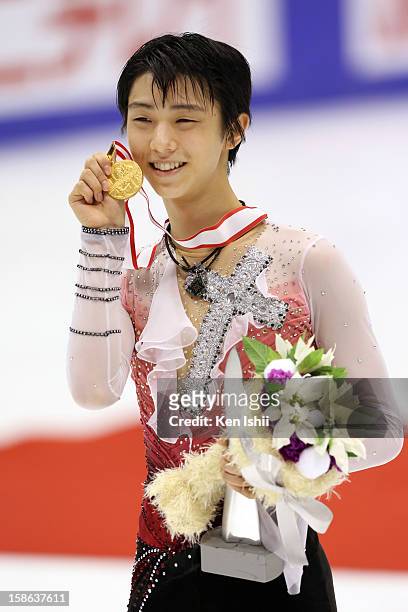 Gold medalist winner Yuzuru Hanyu poses for photographs at the medal ceremony during day two of the 81st Japan Figure Skating Championships at...