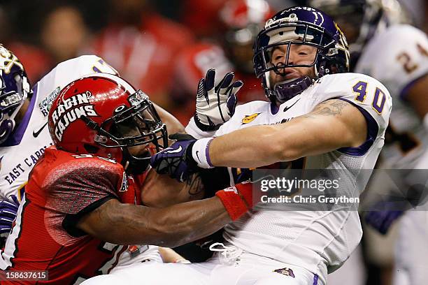 Tyler Morvant of the Louisiana-Lafayette Ragin Cajuns tackles Hunter Furr of the East Carolina Pirates during the R+L Carriers New Orleans Bow at the...