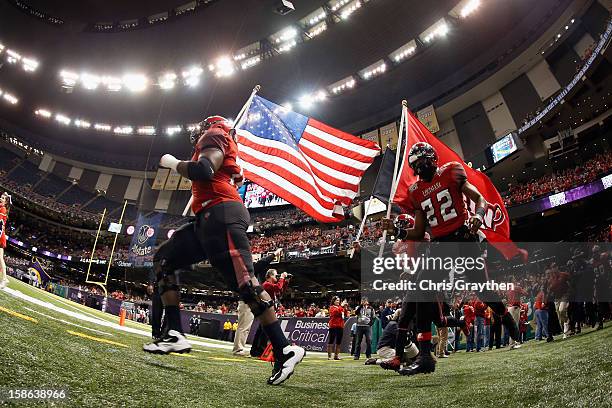 The Louisiana-Lafayette Ragin Cajuns take the field during the R+L Carriers New Orleans Bow at the Mercedes-Benz Superdome on December 22, 2012 in...