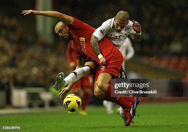 Jose Enrique of Liverpool tangles with Ashkan Dejagah of Fulham during the Barclays Premier League match between Liverpool and Fulham at Anfield on...