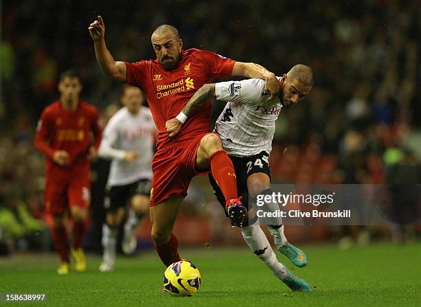 Jose Enrique of Liverpool tangles with Ashkan Dejagah of Fulham during the Barclays Premier League match between Liverpool and Fulham at Anfield on...