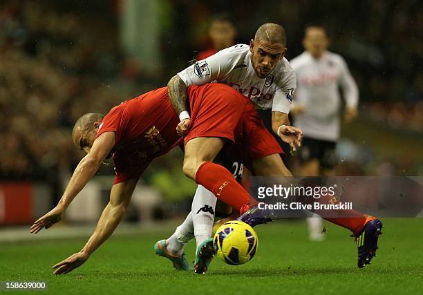 Jose Enrique of Liverpool tangles with Ashkan Dejagah of Fulham during the Barclays Premier League match between Liverpool and Fulham at Anfield on...