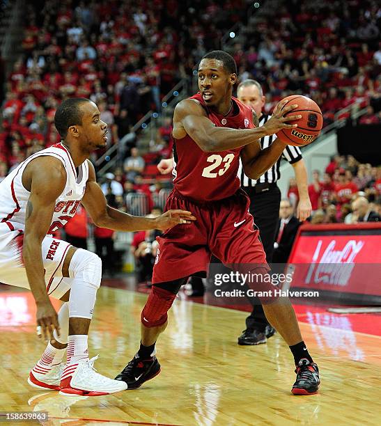 Gabriel Harris of the Stanford Cardinal against Lorenzo Brown of the North Carolina State Wolfpack during play at PNC Arena on December 18, 2012 in...